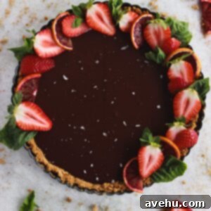 Decadent Dairy Free Chocolate Ganache Tart 2 A chocolate tart topped with strawberries, sea salt, and sliced blood oranges