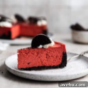 A slice of red velvet cheesecake on a white plate, ready to be enjoyed.