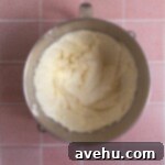 Butter, eggs, and sugar combined in a mixing bowl.