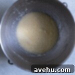 Pillowy Soft Blueberry Cupcakes 3 Creamed butter, sugar, and eggs in a stainless steel bowl.