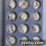 Pillowy Soft Blueberry Cupcakes 6 Blueberry cupcake batter in a muffin tin.