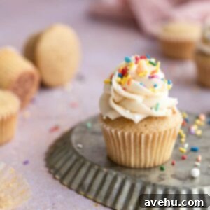 Whip Up Dairy Free Buttercream Frosting in 5 Minutes 2 A cupcake frosted with dairy-free vanilla buttercream and sprinkles, highlighting its perfect piping and delicious appearance.