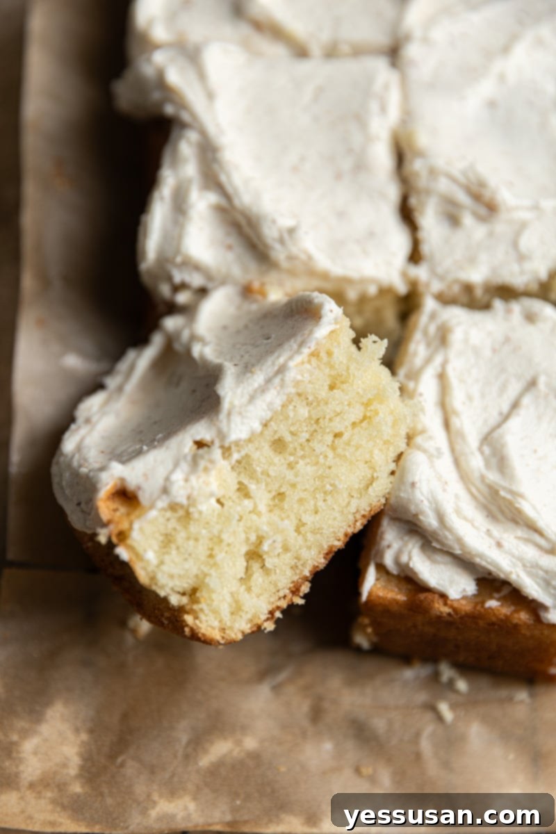 Fluffy Golden Butter Cake 2 A perfectly baked, square piece of fluffy 9x13" butter cake, lightly golden, resting on its side.