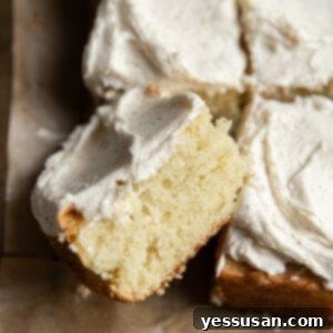 Fluffy Golden Butter Cake 12 A square piece of a 9x13" cake laying on its side.