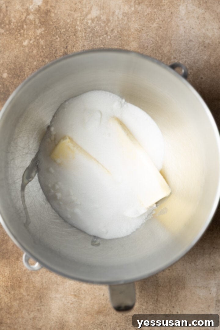 Fluffy Golden Butter Cake 3 Softened butter and granulated sugar ready to be creamed in a stand mixer bowl.
