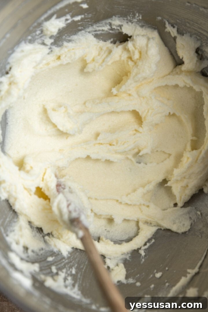 Fluffy Golden Butter Cake 4 Creamed butter and sugar mixture, pale yellow and fluffy, in a mixing bowl.