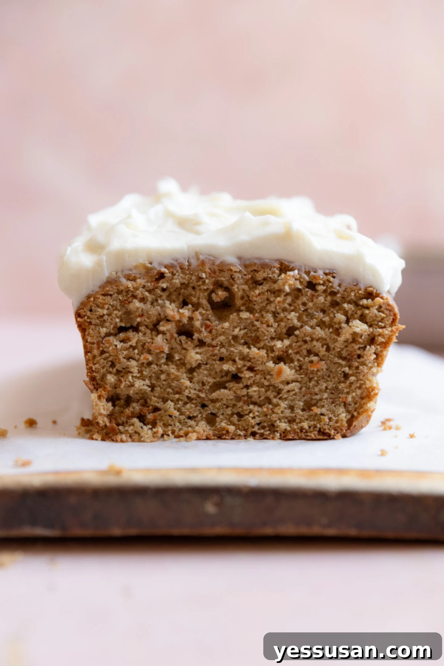 Moist Carrot Loaf: Simple Baking Perfection 2 A perfectly sliced carrot cake loaf on a parchment-lined cutting board.