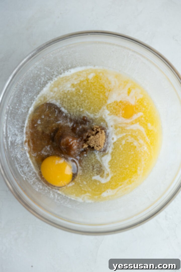 Moist Carrot Loaf: Simple Baking Perfection 3 Wet ingredients and brown sugar combined in a mixing bowl.