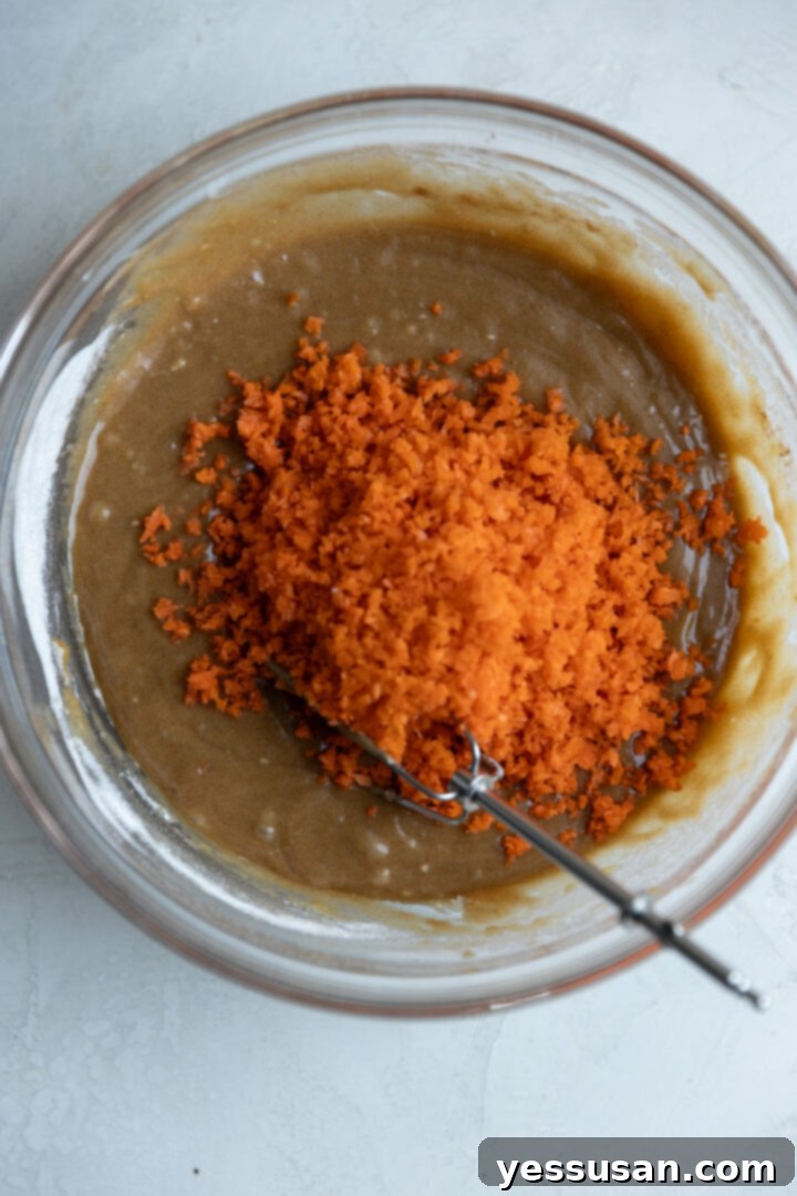 Moist Carrot Loaf: Simple Baking Perfection 6 Carrot cake loaf batter in a glass bowl, awaiting baking.